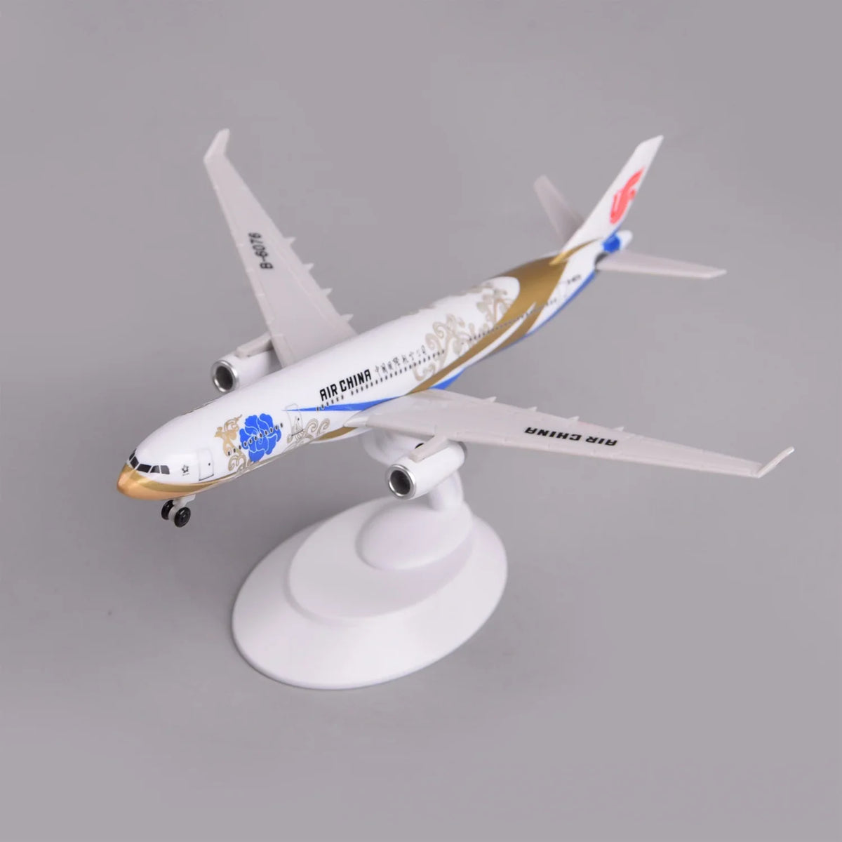 Air China A330 Zichen model plane on its display stand, front three-quarter view of the nose and gold swoosh