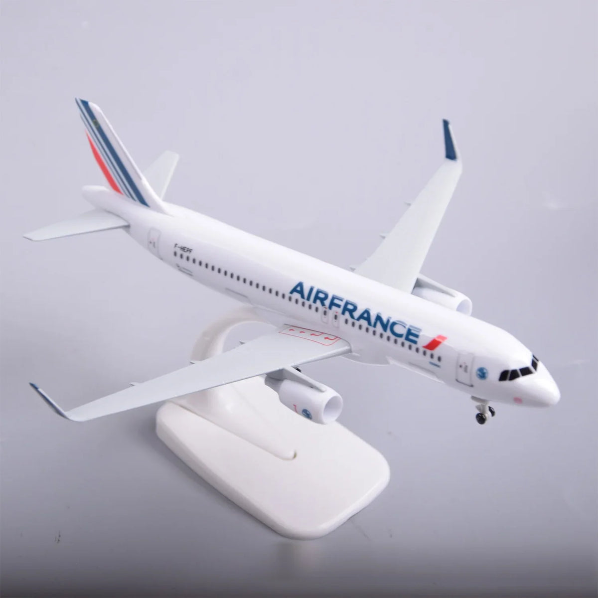 Air France A320 model plane on its display stand, front three-quarter view