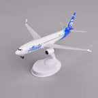 Front three-quarter view of the Alaska Airlines 737 MAX 8 model on its display stand
