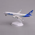 Alaska Airlines 737 MAX 8 desk model in a climbing takeoff pose on its display stand, side view