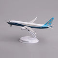Boeing 737 MAX 8 prototype livery desk model in a climbing takeoff pose on its display stand, side view