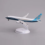 Boeing 737 MAX 8 prototype livery desk model in a climbing takeoff pose on its display stand, side view