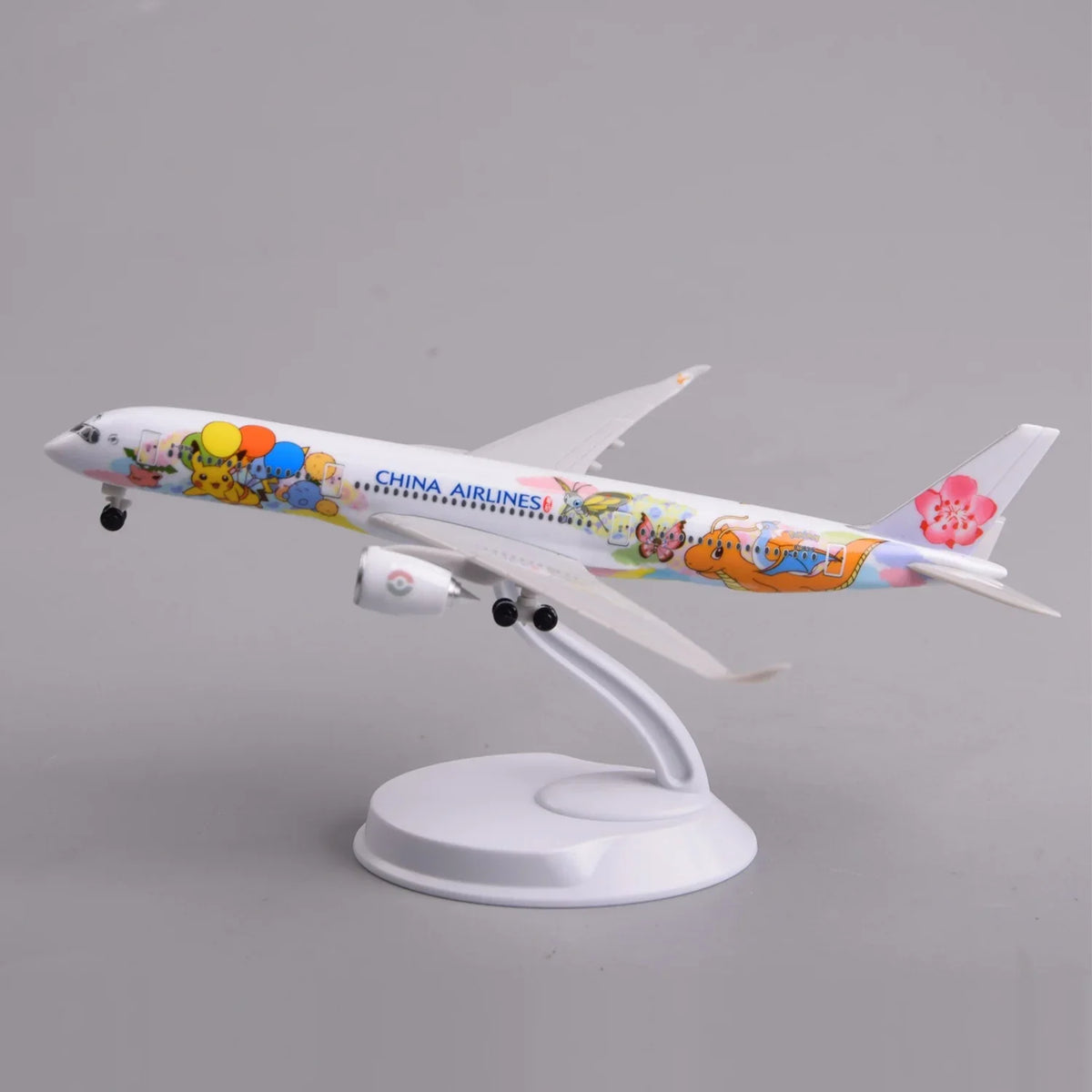China Airlines A350 special-livery desk model in a climbing takeoff pose on its display stand, side view