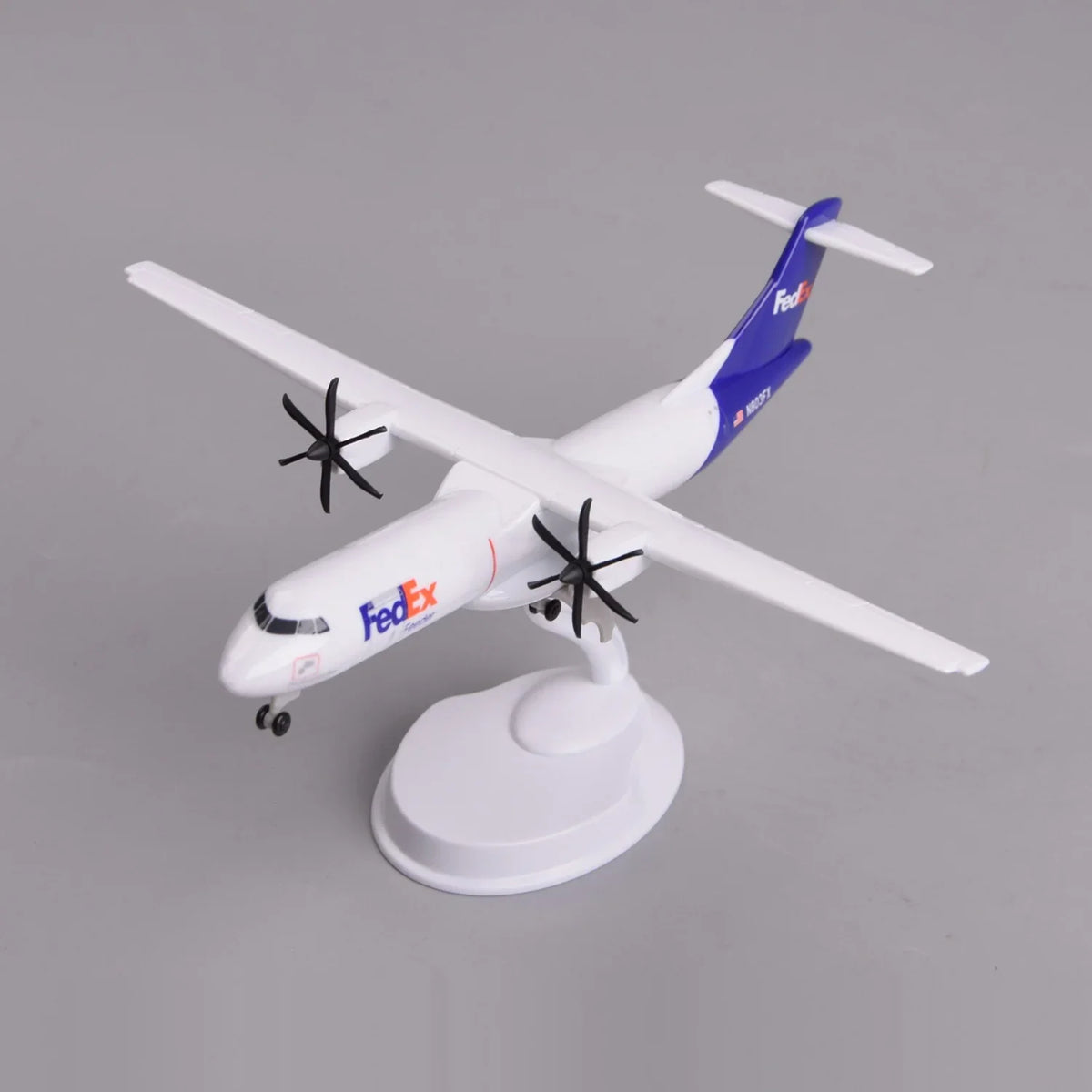 Front three-quarter view of the FedEx ATR 72-600 freighter model on its display stand