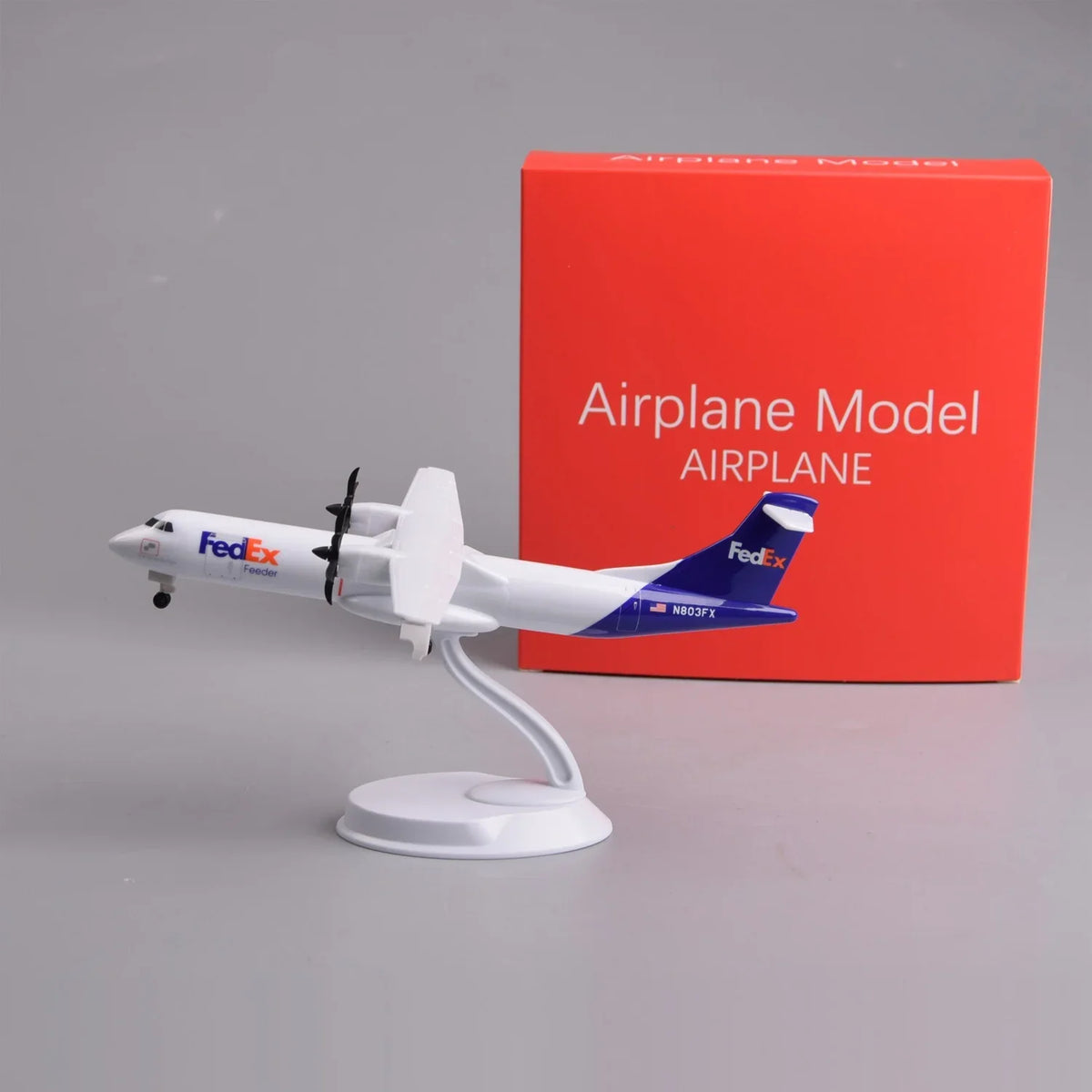 FedEx ATR 72-600 8-inch model on its display stand next to its red gift box