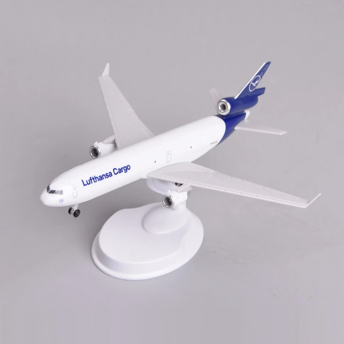 Front three-quarter view of the Lufthansa Cargo MD-11 model on its display stand