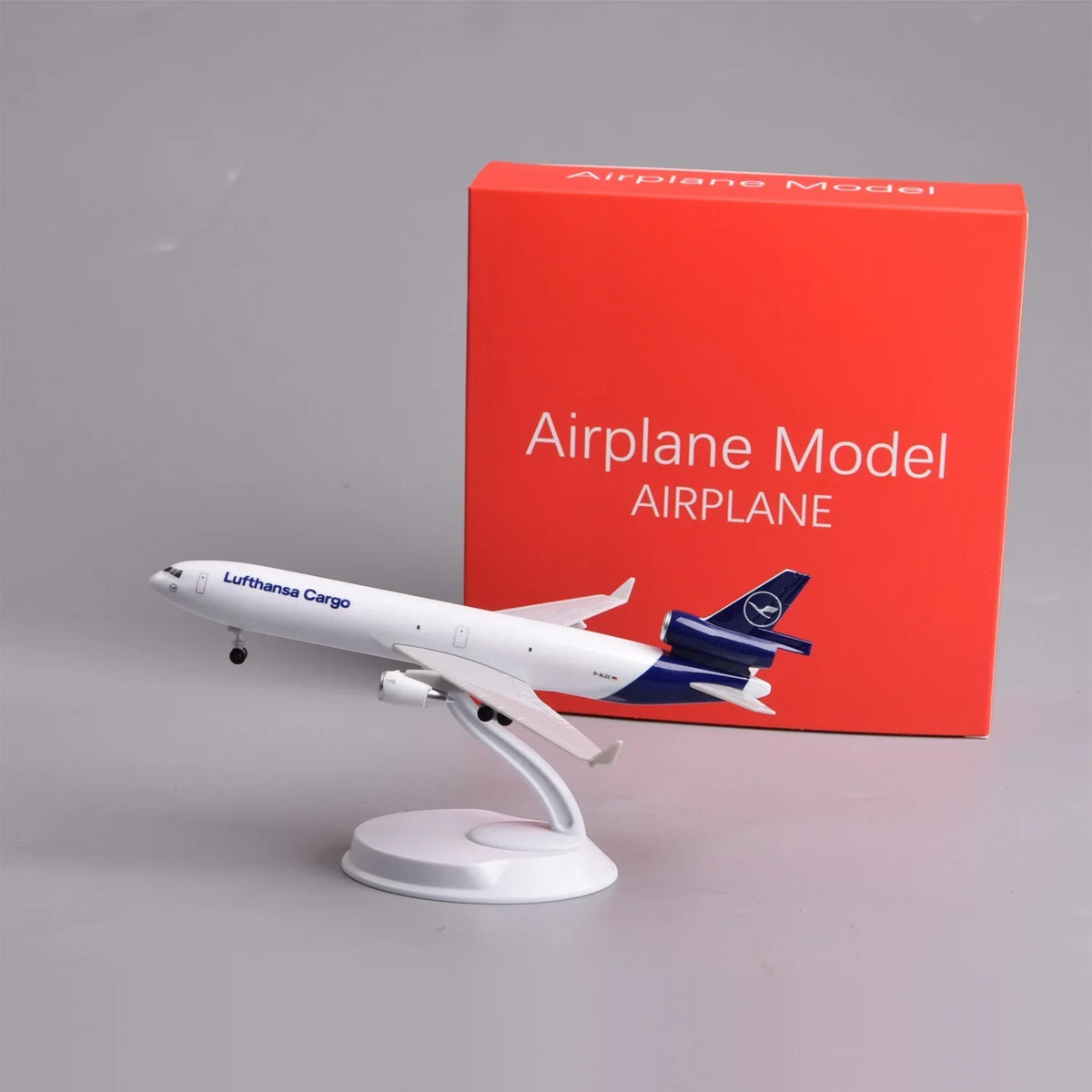 Lufthansa Cargo MD-11 8-inch model on its display stand next to its red gift box