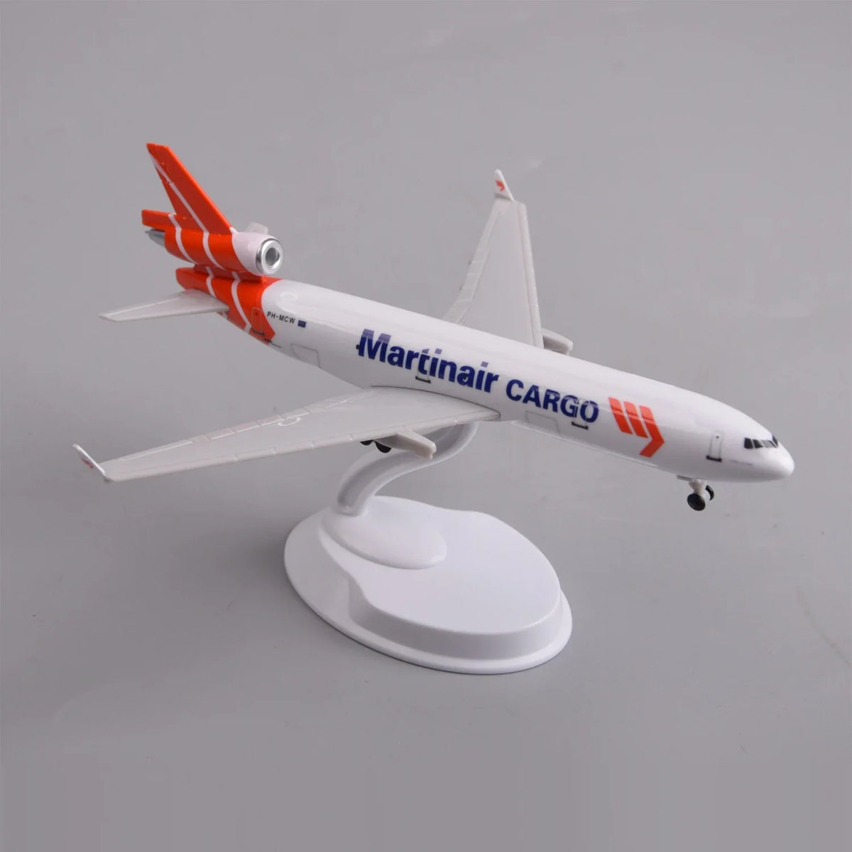 Rear three-quarter view of the Martinair MD-11 model showing the tri-jet orange tail fins