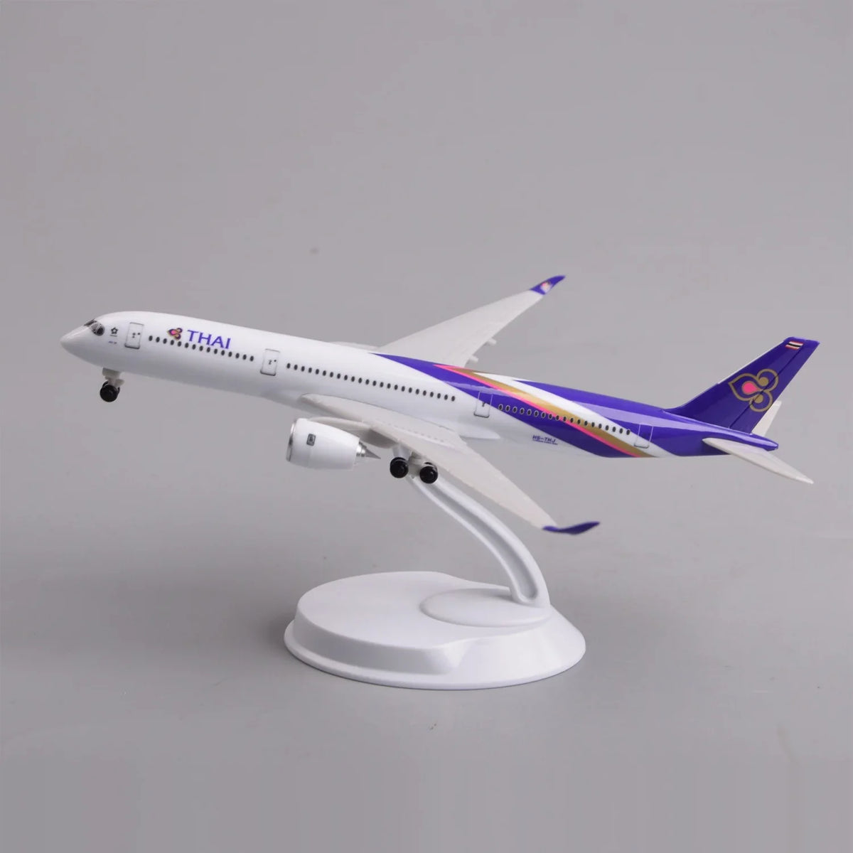 Thai Airways A350 desk model in a climbing takeoff pose on its display stand, side view