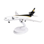 UPS MD-11 cargo jet scale model, 8-inch resin freighter on white display stand, front three-quarter view on white background