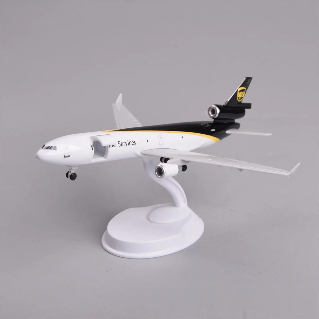 UPS MD-11 model plane in brown and gold livery mounted on its display stand, view from the nose