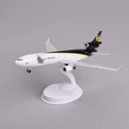 UPS MD-11 model plane in brown and gold livery mounted on its display stand, view from the nose