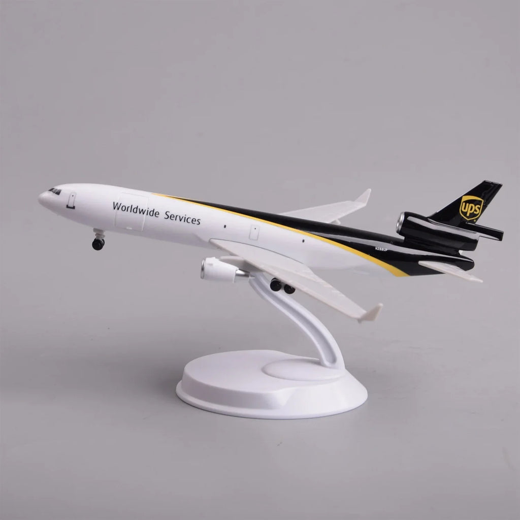 UPS MD-11 cargo jet model in a climbing takeoff pose on its display stand, side view
