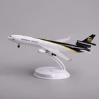 UPS MD-11 cargo jet model in a climbing takeoff pose on its display stand, side view